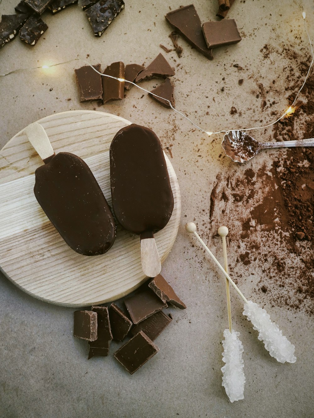 a wooden plate topped with ice cream and chocolate