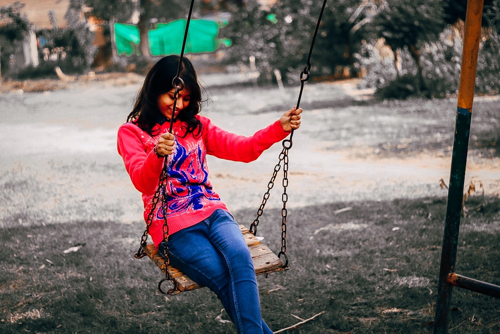 photography of woman sits on swing chair