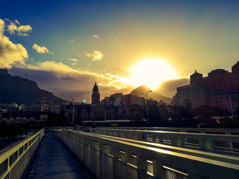 city with high-rise buildings viewing road under yellow sky