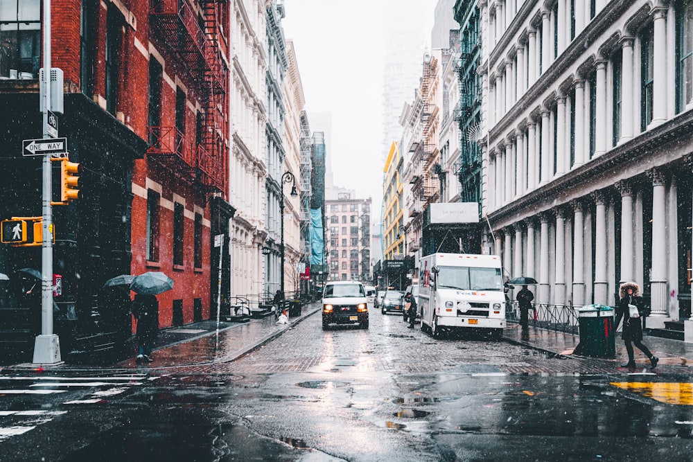 vehicle crossing road between buildings