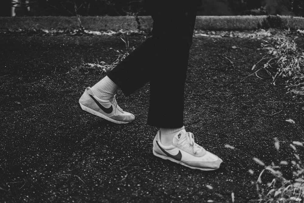 a black and white photo of a person's shoes