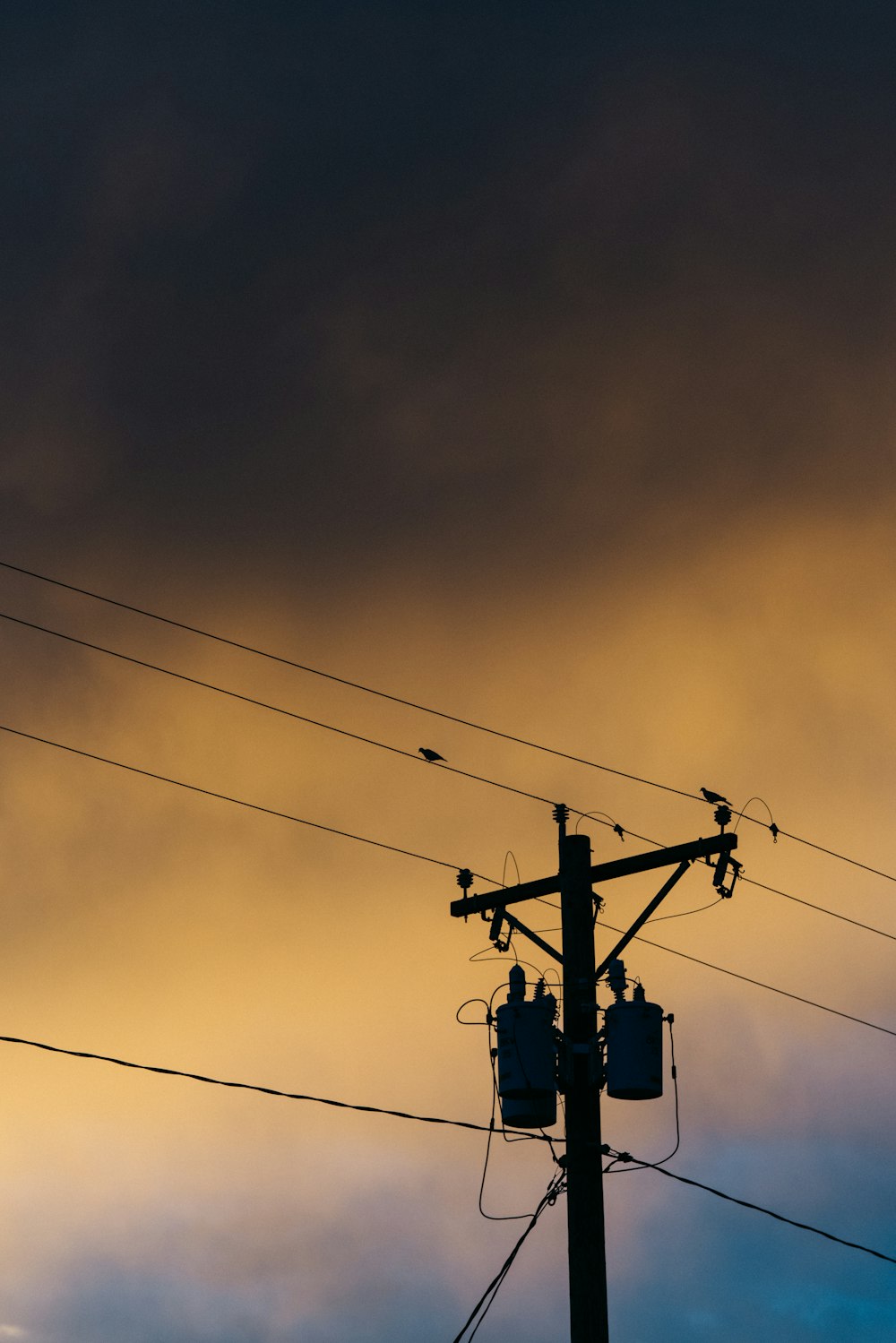 a telephone pole with a sky in the background