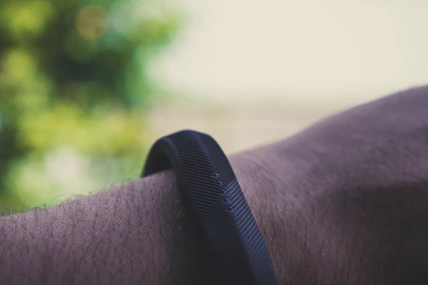 Close-up of a fitness tracker glowing on a runner’s wrist during an early morning jog.