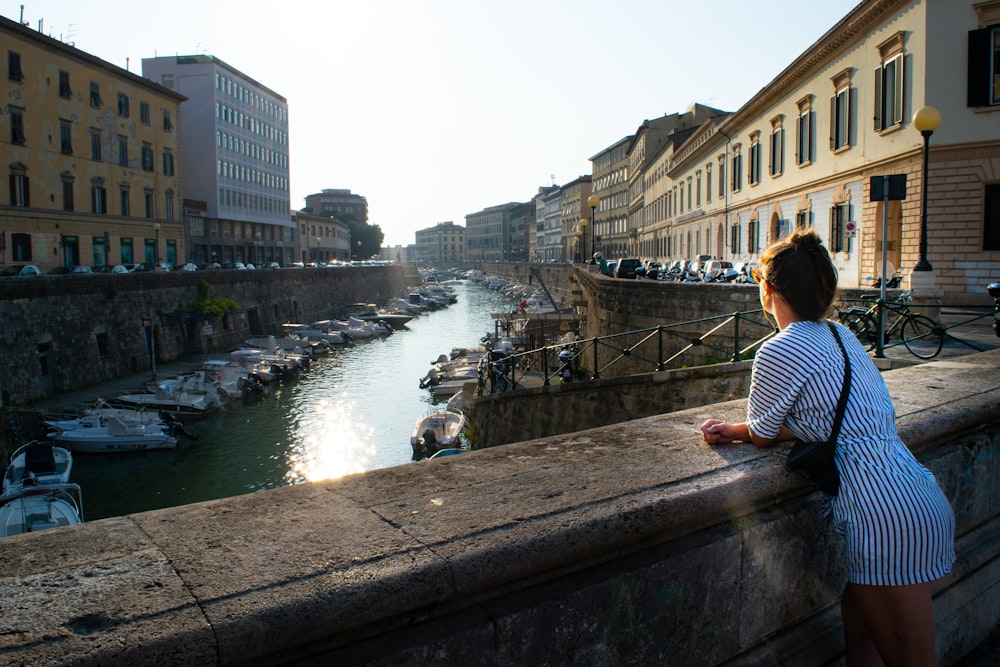 woman leaning on concrete wall