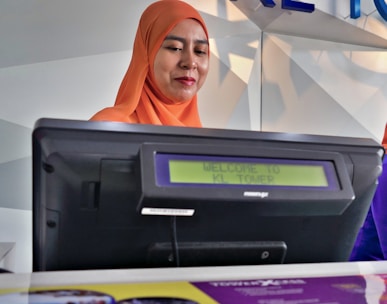 woman beside black monitor