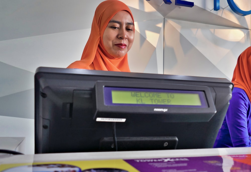 woman beside black monitor