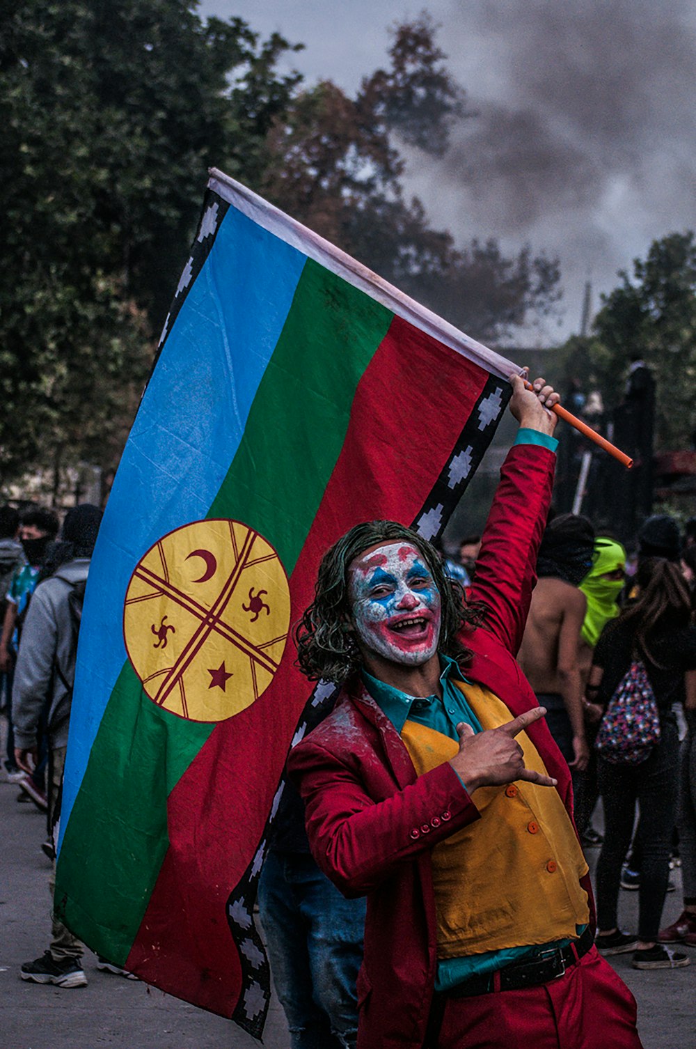 a man with a painted face holding a flag