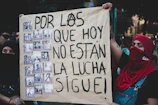 A group of supporters holding handmade signs advocating for contact visits.