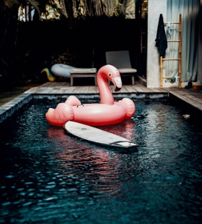 pink flamingo floating ring on bed