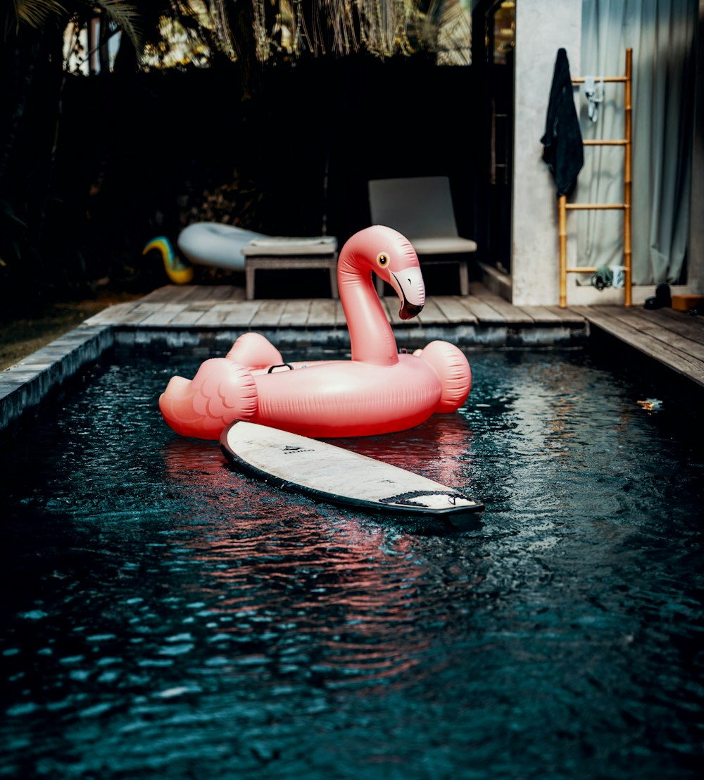 pink flamingo floating ring on bed