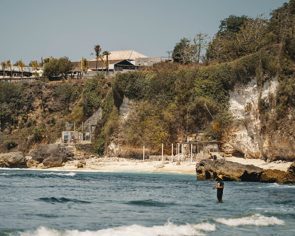 photography of man standing near seashore during daytime