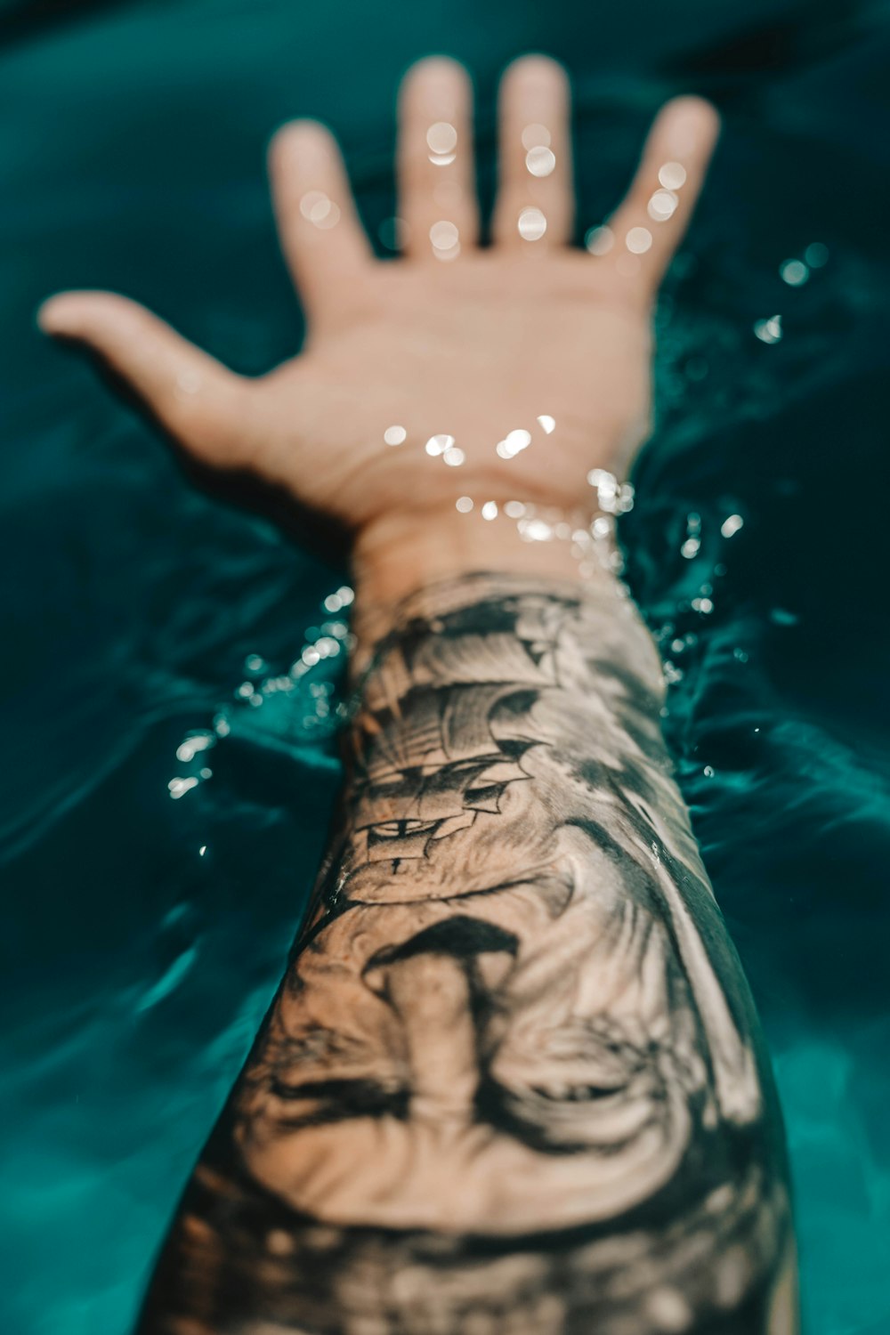 man's portrait arm tattoo