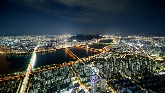 wide-angle photography of buildings during nighttime in Lotte World Tower South Korea