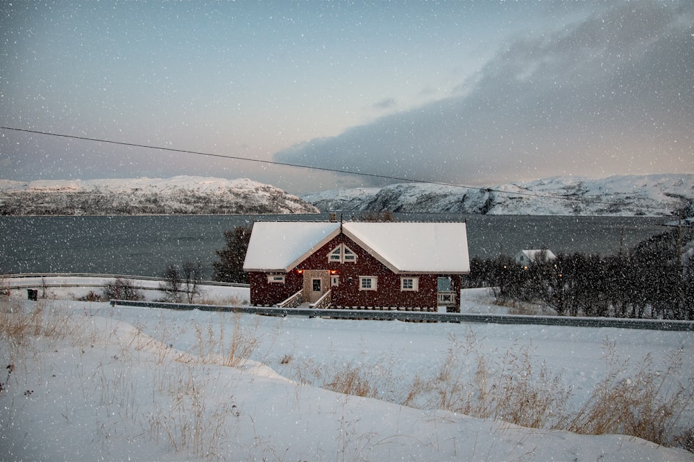 red and white house beside of lake