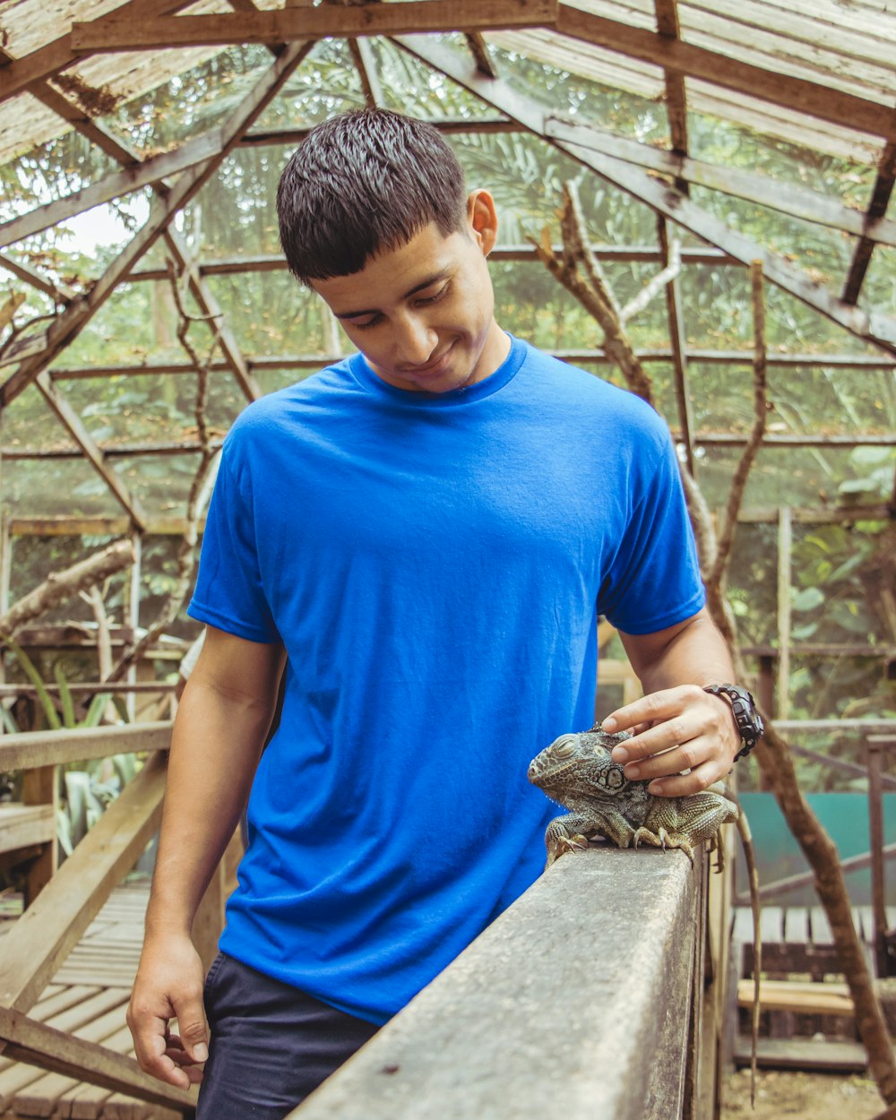 man holding iguana