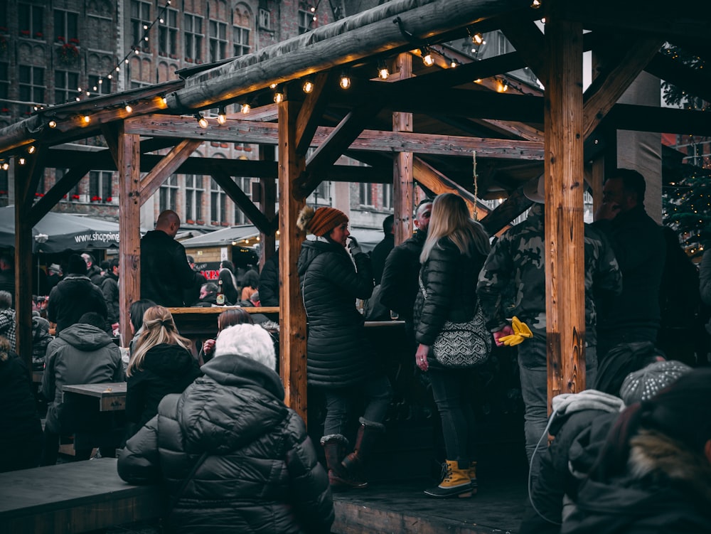 people standing in wooden structures