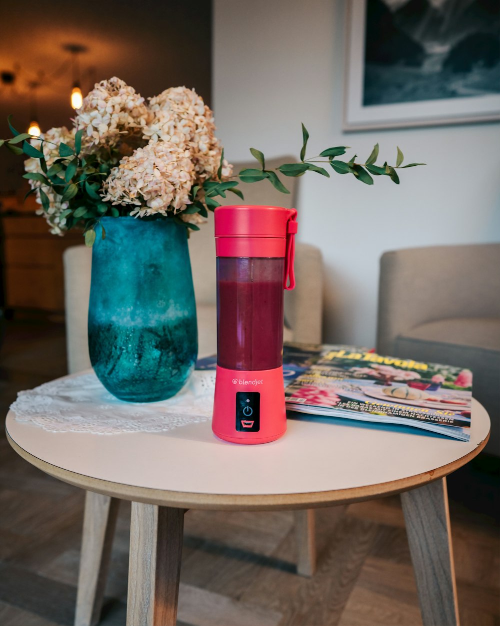 pink tumbler beside blue vase