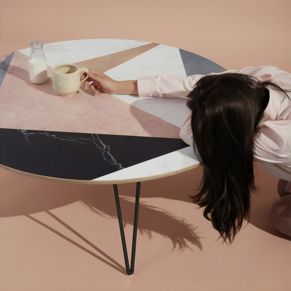 woman leaning on table with mug