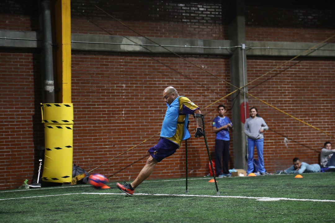 person with food disability playing soccer