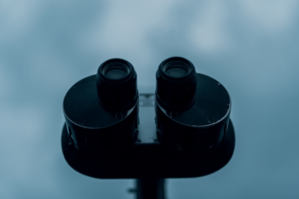 a pair of binoculars sitting on top of a pole