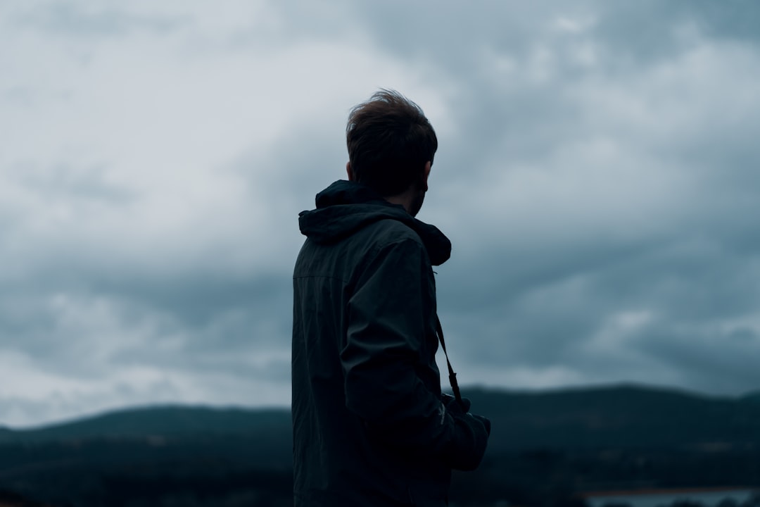 man wearing black hooded jacket