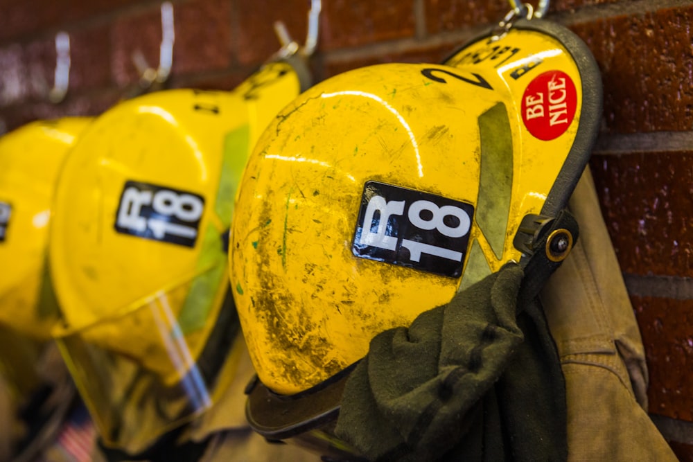 yellow and black helmet hanging on wall