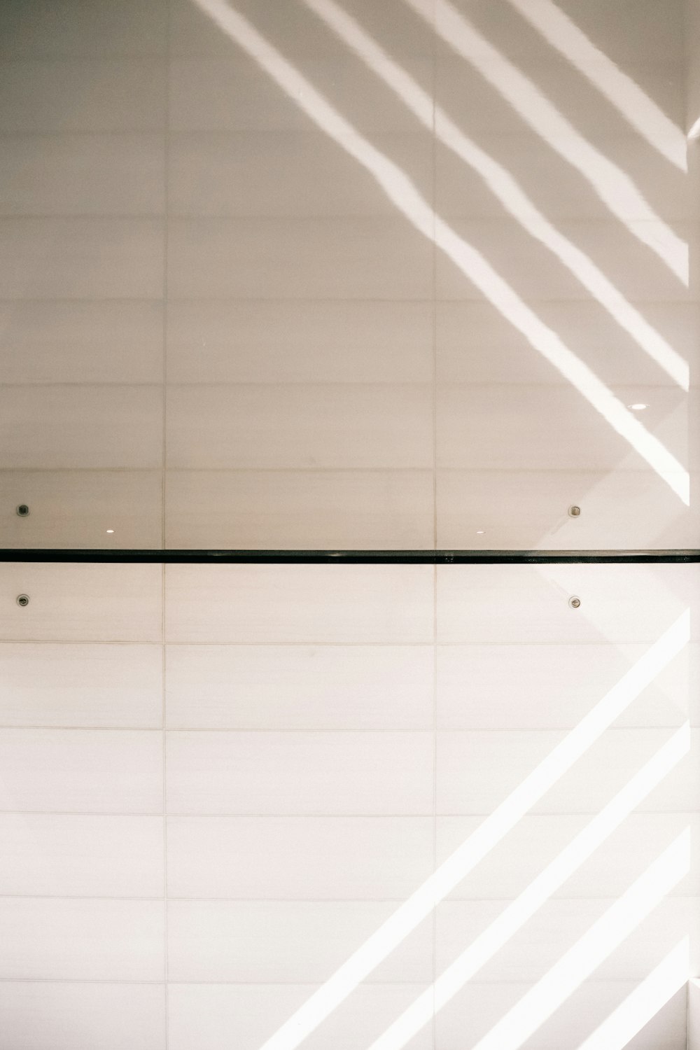 a white wall with a long shadow on it