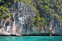 mountain near body of water, coats of khanom, home of pink dolphins