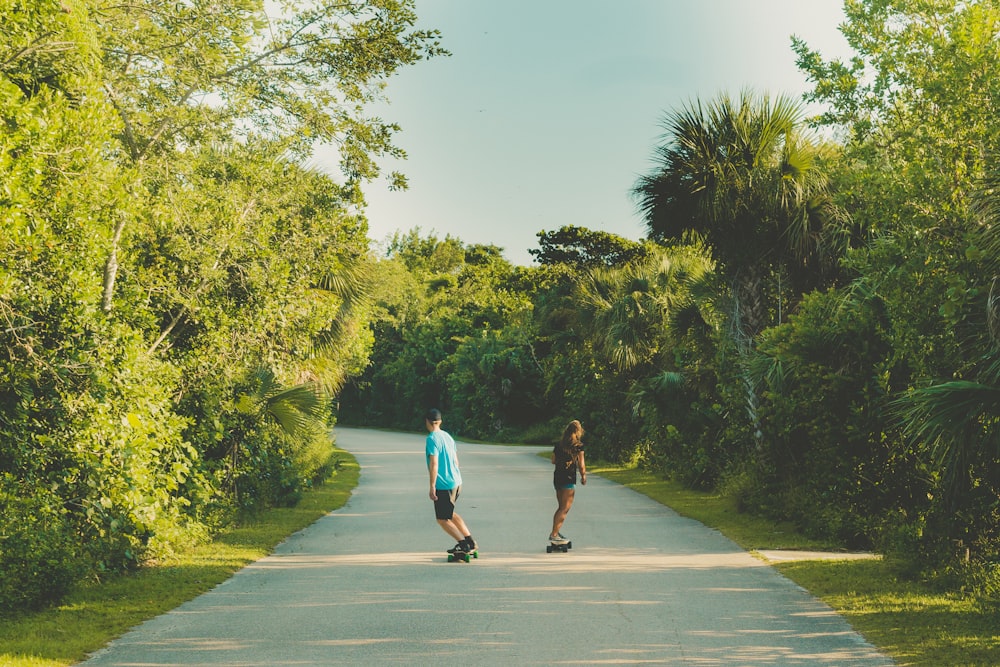shallow focus photo of two person riding skateboards during daytime