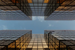 worm view photo of buildings under cloudy sky