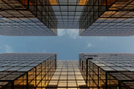 worm view photo of buildings under cloudy sky