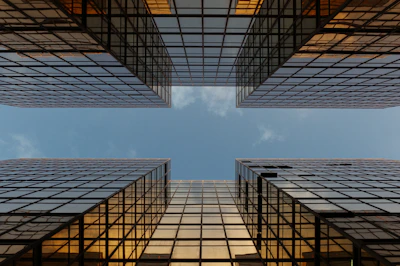 worm view photo of buildings under cloudy sky
