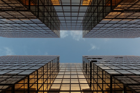 worm view photo of buildings under cloudy sky