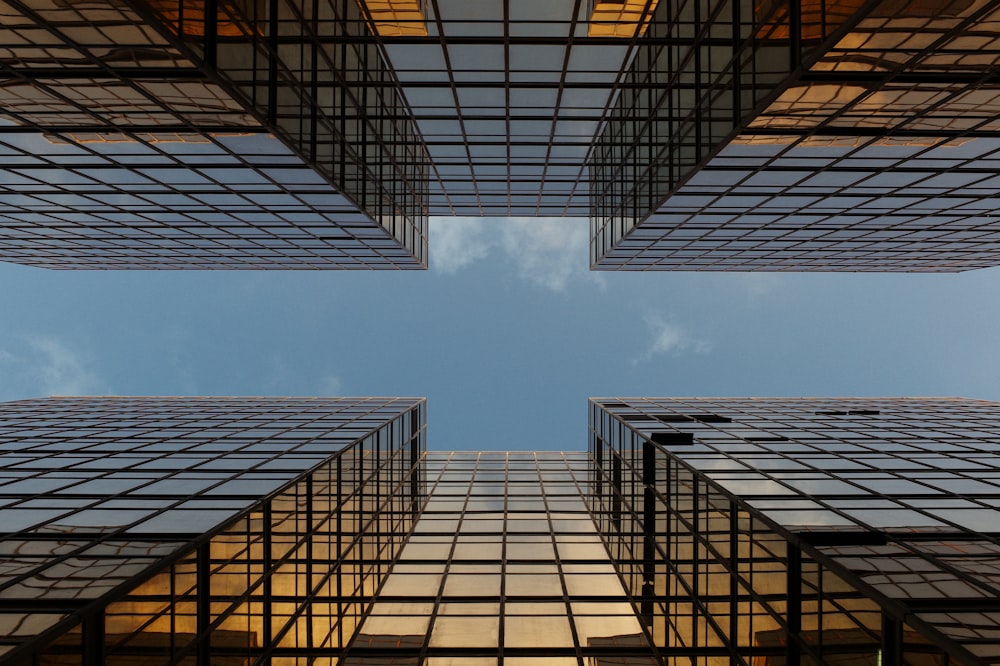 worm view photo of buildings under cloudy sky