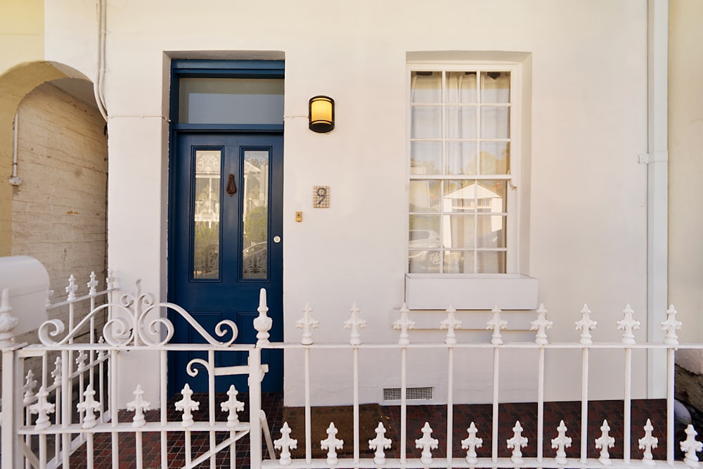 white house near metal fence