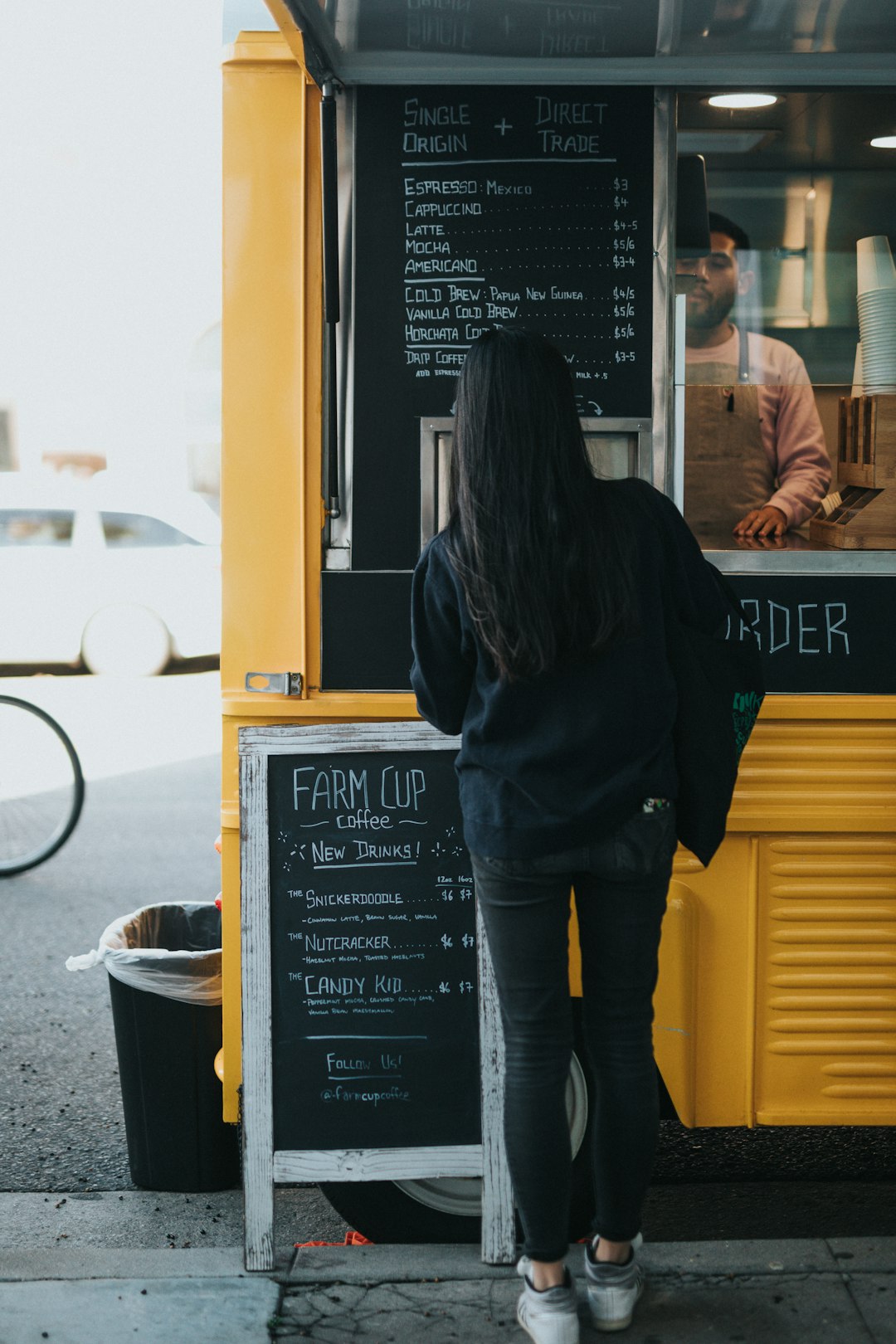 woman standing beside take out counter