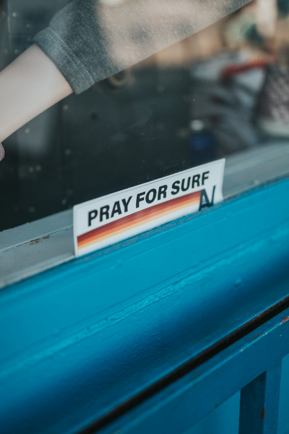 a sticker on a window saying pray for sure