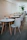 Cozy café seating area with minimalist decor and a yoga mat rolled up nearby.