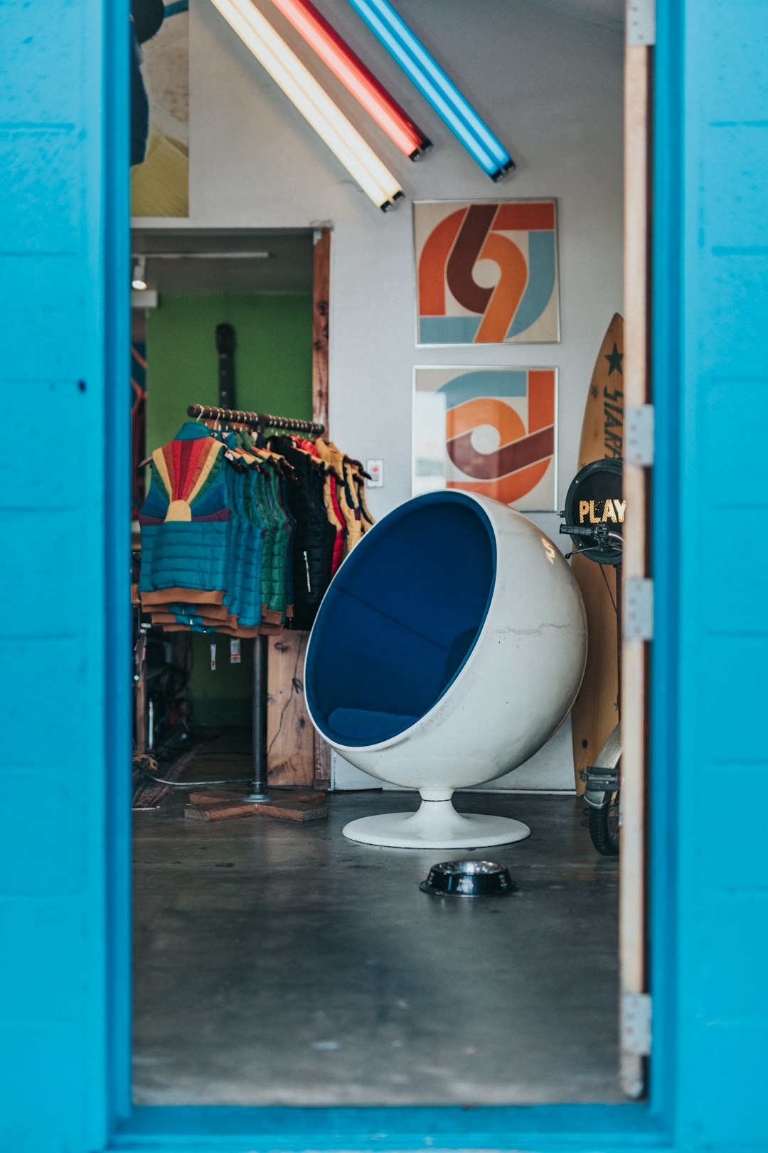 blue and white egg chair beside wall