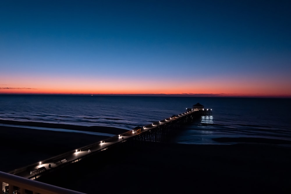 a view of a pier at night from a balcony