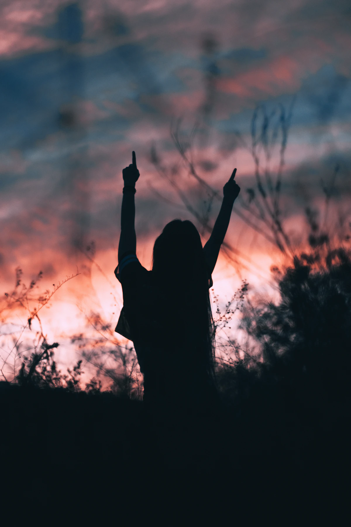 Woman raising her hands toward the sun