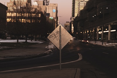 A quiet urban scene at dusk showing graffiti reflecting social commentary.