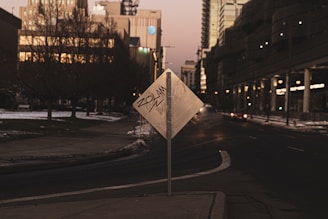 A quiet urban scene at dusk showing graffiti reflecting social commentary.