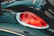 Close-up of a sleek black car with freshly tinted windows reflecting city lights at dusk.