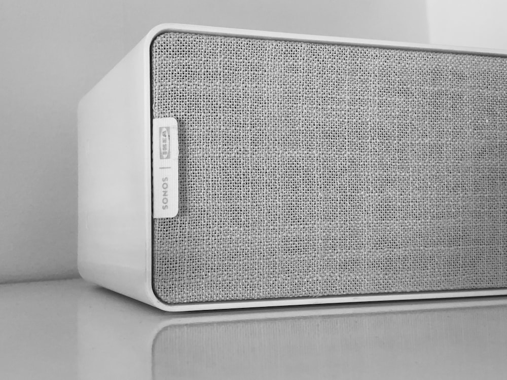 gray speaker on white surface