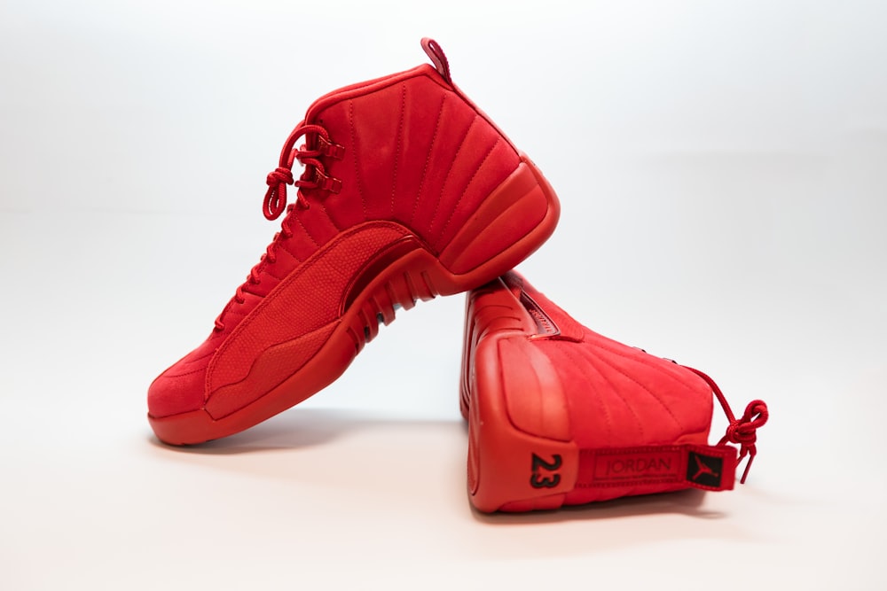 pair of red Air Jordan 12's