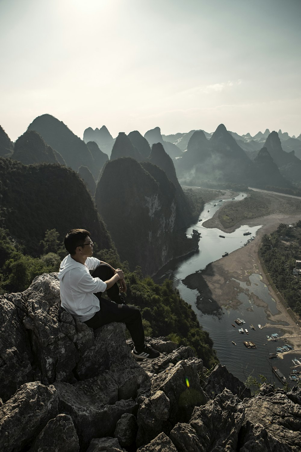 man sitting on cliff