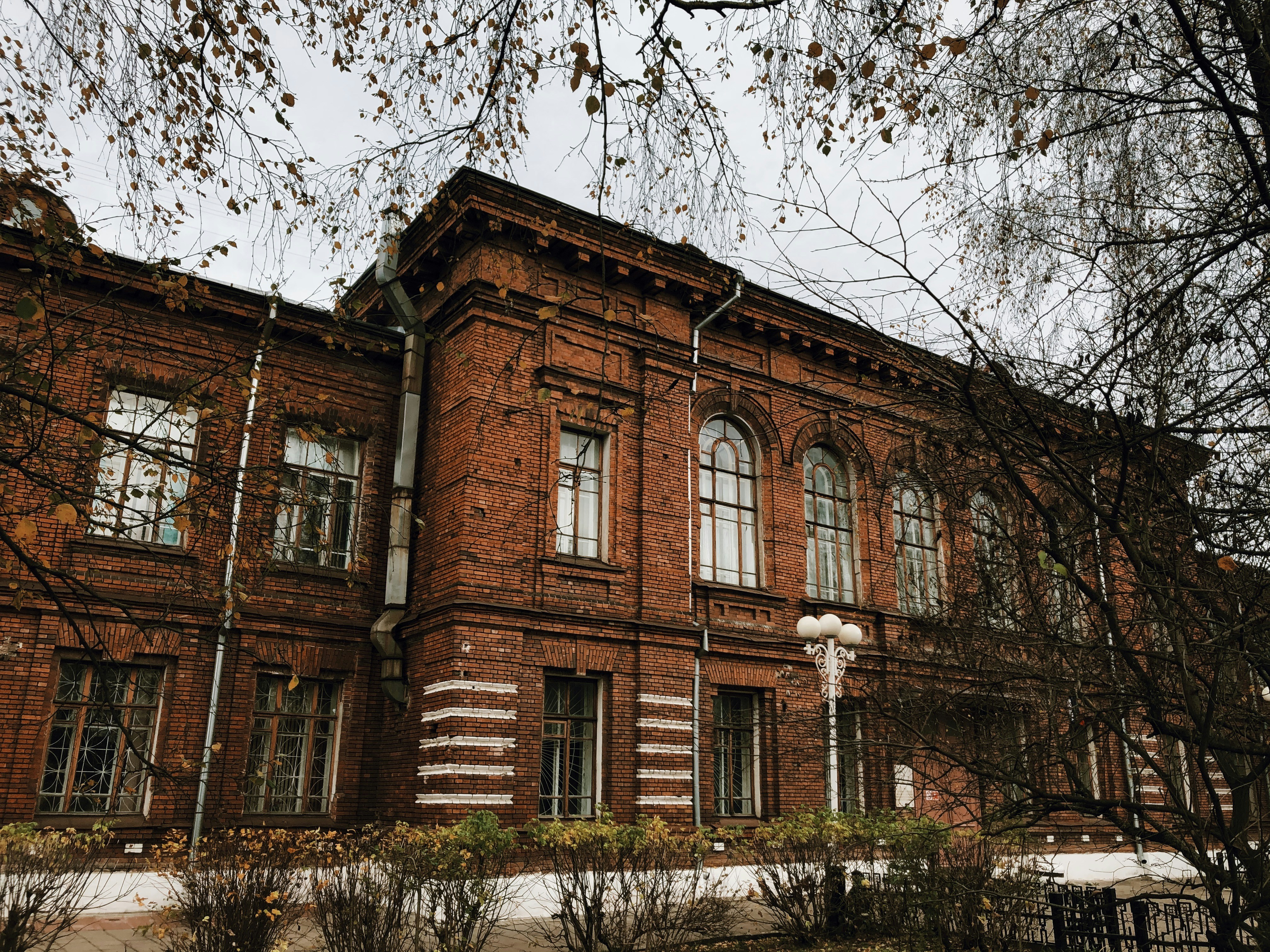 post lamp beside brown brick structure