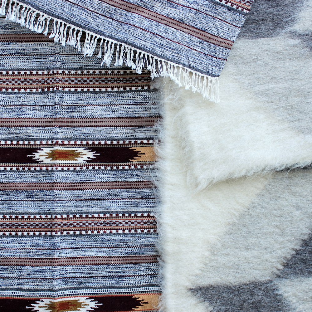 black, blue, and brown tribal print area rug