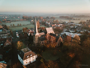 aerial photography of houses on green field during daytime